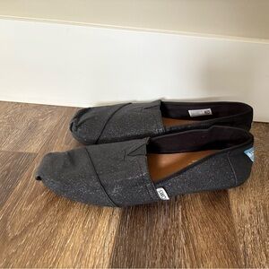 TOMS Black Glitter Slip-On Shoes.
9w